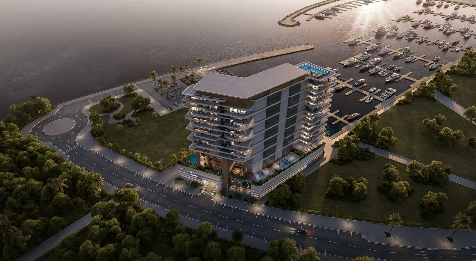 Dusk aerial of The Bay Interiors by Missoni on Dubai Islands between the road and the Island A yacht marina, with a rooftop pool